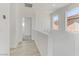 Light-filled hallway with wood-look floors and access to other rooms at 9570 Wenmarie Ct, Las Vegas, NV 89148