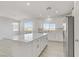 Modern kitchen with large island, white cabinets, and stainless steel appliances at 9570 Wenmarie Ct, Las Vegas, NV 89148