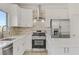 Contemporary kitchen with stainless steel appliances and white shaker cabinets at 9570 Wenmarie Ct, Las Vegas, NV 89148