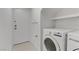 Bright laundry room with washer, dryer, and built-in shelving at 9570 Wenmarie Ct, Las Vegas, NV 89148