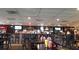 Long bar with multiple tv screens, various liquors, and seating at 988 Via Panfilo Ave, Henderson, NV 89011