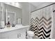 Bathroom with white vanity, chevron shower curtain at 988 Via Panfilo Ave, Henderson, NV 89011