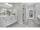 Elegant bathroom with double vanity, large shower, and floor-to-ceiling mirror at 988 Via Panfilo Ave, Henderson, NV 89011