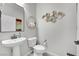 Simple bathroom with pedestal sink and decorative wall art at 988 Via Panfilo Ave, Henderson, NV 89011