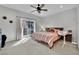 Spacious bedroom with king bed, balcony access, and ceiling fan at 988 Via Panfilo Ave, Henderson, NV 89011