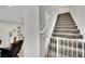 Modern staircase with grey carpet and white railing at 988 Via Panfilo Ave, Henderson, NV 89011