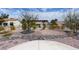 Landscaped backyard with gravel, drought-tolerant plants, and a solar panel system at 9900 Rosamond Dr, Las Vegas, NV 89134