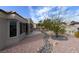 Landscaped backyard with a rock pathway and desert plants at 9900 Rosamond Dr, Las Vegas, NV 89134