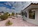 Landscaped backyard with a rock pathway and desert plants at 9900 Rosamond Dr, Las Vegas, NV 89134