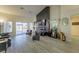 Spacious living room with hardwood floors, fireplace, and large windows at 9900 Rosamond Dr, Las Vegas, NV 89134