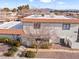 View of the townhouse building, showcasing its architectural style and landscaping at 1008 Willow Tree Dr # B, Las Vegas, NV 89128