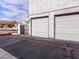 Two-car garage with white doors and driveway at 1008 Willow Tree Dr # B, Las Vegas, NV 89128