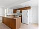 Kitchen with wood cabinets and white appliances at 1008 Willow Tree Dr # B, Las Vegas, NV 89128