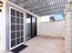 Covered patio with brick wall and sliding glass door at 1008 Willow Tree Dr # B, Las Vegas, NV 89128