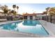 Community pool with surrounding benches and landscaping at 1008 Willow Tree Dr # B, Las Vegas, NV 89128