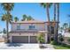 Two-story house with three-car garage and palm trees at 1015 Aspen Breeze Ave, Las Vegas, NV 89123