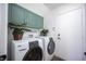 Convenient laundry room with washer, dryer, and cabinets at 1015 Aspen Breeze Ave, Las Vegas, NV 89123