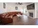 Relaxing living room with brown leather sectional sofa and fireplace at 1015 Aspen Breeze Ave, Las Vegas, NV 89123