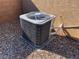 Exterior shot of the home's air conditioning unit with protective grate, set atop a gravel base at 10260 Danskin Dr, Las Vegas, NV 89166