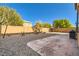 Landscaped backyard with gravel, patio, and a built-in grill at 10260 Danskin Dr, Las Vegas, NV 89166