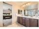 Bathroom with a double vanity, mirror, and a doorway view of the main bedroom at 10260 Danskin Dr, Las Vegas, NV 89166