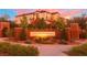 Attractive community entrance with landscaping and signage at sunset at 10260 Danskin Dr, Las Vegas, NV 89166