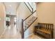 Welcoming entryway with tile floors, staircase, and a charming wooden bench at 10260 Danskin Dr, Las Vegas, NV 89166