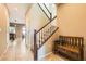 Entryway with tiled floor, wooden bench, and staircase at 10260 Danskin Dr, Las Vegas, NV 89166