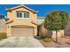 Two-story home featuring an attached garage, a well-manicured lawn, and mature trees at 10260 Danskin Dr, Las Vegas, NV 89166