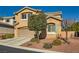 Two-story home with desert landscaping, a two-car garage, and a neutral color palette at 10260 Danskin Dr, Las Vegas, NV 89166