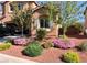 Landscaped front yard with flowering bushes at 10260 Danskin Dr, Las Vegas, NV 89166