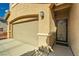 Two-car garage and ornately detailed black front door at 10260 Danskin Dr, Las Vegas, NV 89166