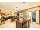 Kitchen with island, dark wood cabinets, granite countertops, and view to living area at 10260 Danskin Dr, Las Vegas, NV 89166