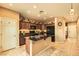 Kitchen with island, dark wood cabinets, and granite countertops at 10260 Danskin Dr, Las Vegas, NV 89166