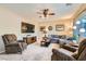 Inviting living room featuring a ceiling fan, plush seating, and a large window at 10260 Danskin Dr, Las Vegas, NV 89166