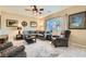 Comfortable living room featuring a sectional sofa, ceiling fan, and neutral decor at 10260 Danskin Dr, Las Vegas, NV 89166