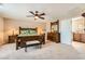 Main bedroom with king-size bed, ensuite bathroom access, and ceiling fan at 10260 Danskin Dr, Las Vegas, NV 89166