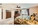 Serene main bedroom featuring a ceiling fan, dresser, TV, and ensuite bathroom at 10260 Danskin Dr, Las Vegas, NV 89166