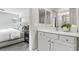 Bathroom with white cabinets, modern fixtures, and a view into the bedroom at 104 Alamere Falls Dr, Las Vegas, NV 89138