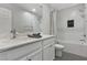 Clean bathroom with subway tile, bathtub, and quartz vanity at 104 Alamere Falls Dr, Las Vegas, NV 89138