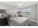 Neutral bedroom features a large bed, dark end tables, and a window with natural light at 104 Alamere Falls Dr, Las Vegas, NV 89138