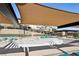 Community pool with shade structure and lounge seating offers a relaxing and social outdoor space for residents at 104 Alamere Falls Dr, Las Vegas, NV 89138