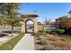 Welcoming entrance to Santa Rosa community, featuring a charming archway and well-manicured landscaping, creating a serene ambiance at 104 Alamere Falls Dr, Las Vegas, NV 89138