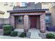 Charming home exterior with a covered entryway, brick pillars and manicured landscaping at 104 Alamere Falls Dr, Las Vegas, NV 89138