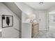 Bright hallway featuring a decorative table with drawers, artwork, and access to other rooms at 104 Alamere Falls Dr, Las Vegas, NV 89138