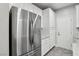 Modern kitchen with stainless steel refrigerator and white cabinets at 104 Alamere Falls Dr, Las Vegas, NV 89138