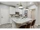 Modern kitchen with white cabinets, granite countertops, and stainless steel appliances at 104 Alamere Falls Dr, Las Vegas, NV 89138