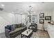 Living room with gray sofa, white shiplap wall, and wood floors at 104 Alamere Falls Dr, Las Vegas, NV 89138