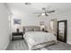 Cozy bedroom features carpet flooring, a ceiling fan, and an ensuite bathroom at 104 Alamere Falls Dr, Las Vegas, NV 89138