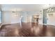 Open-concept living area with hardwood floors, open floor plan to kitchen, and bright lighting at 109 Ayesha Ln, Henderson, NV 89074